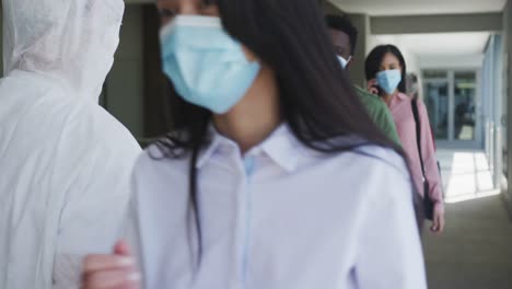 People-standing-in-a-queue-and-getting-their-temperature-checked