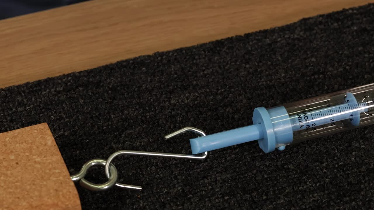 Spring Scale on Dark Surface