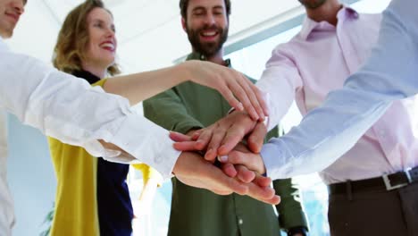 business executives doing hand stack on table