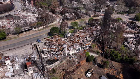 aerial view of devastation after a wildfire, showing residential areas reduced to rubble