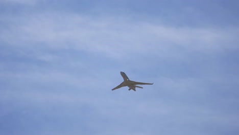 low angle tracking shot overflying private jet plane after takeoff