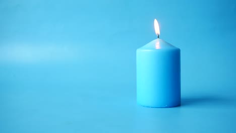 blue candle on blue background