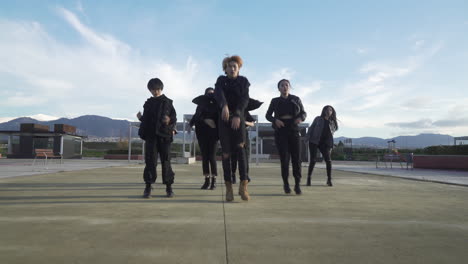 young street performer performing on the street. seven chinese teenagers dancing kpop