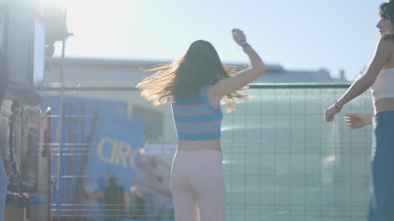 Three women dancing outdoors