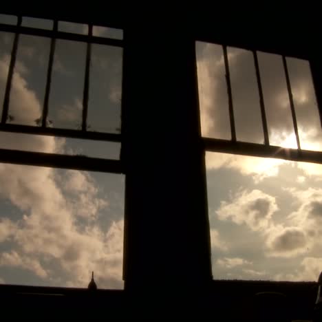 an abstract conceptual shot looking at clouds outside of a window in time lapse