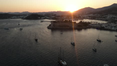 port with many ships in bodrum in turkey at sunset, sea, filmed by drone