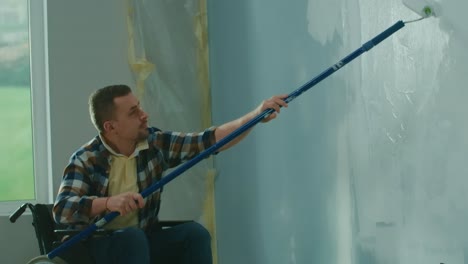 Man in Wheelchair Painting a Wall