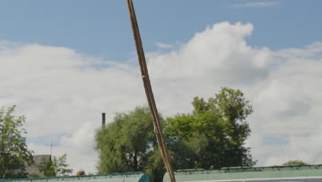 Crane-prepared-to-lift-old-car-with-straps-for-recycling-in-scrapyard