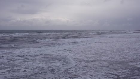 dark waves roll in on this moody and mystical ocean scene during a storm on the atlantic