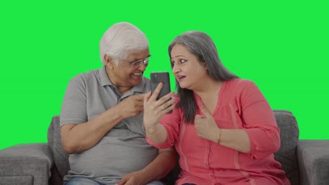 Happy-Old-Indian-couple-talking-on-video-call-Green-screen