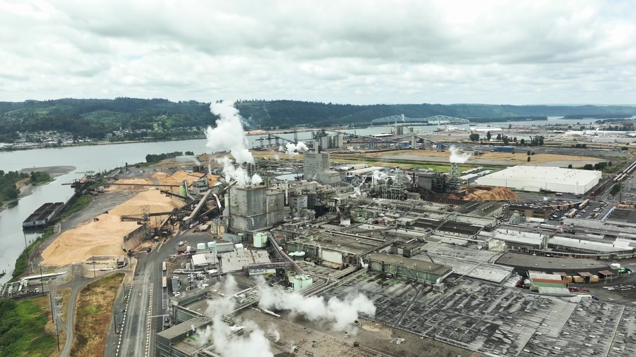 Industrial complex with smoke by river in Longview, USA