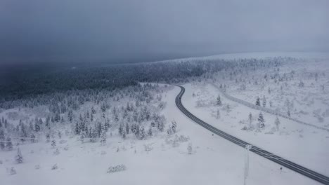 drone following the main road to inari, gloomy winter day in saariselka, finland