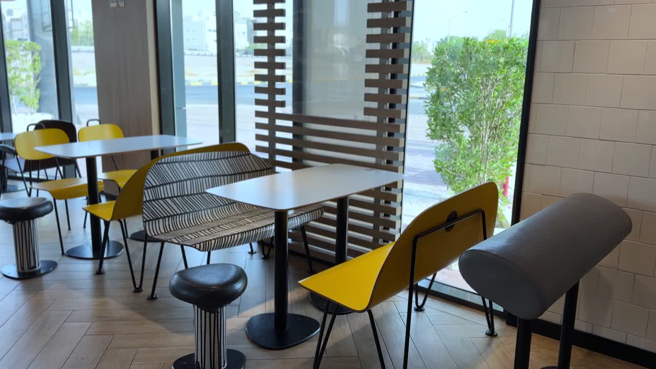 Bright urban café interior with modern chairs, natural light, and clean design—perfect for lifestyle, commercial, or workspace projects.