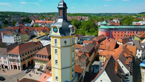 4k aerial drone video of the historic herrieder clock tower in the old town area of downtown ansbach, germany