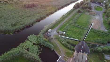 The-green-pasture,-peaceful-rivers-and-a-windmill-in-Kinderdijk,-Netherlands