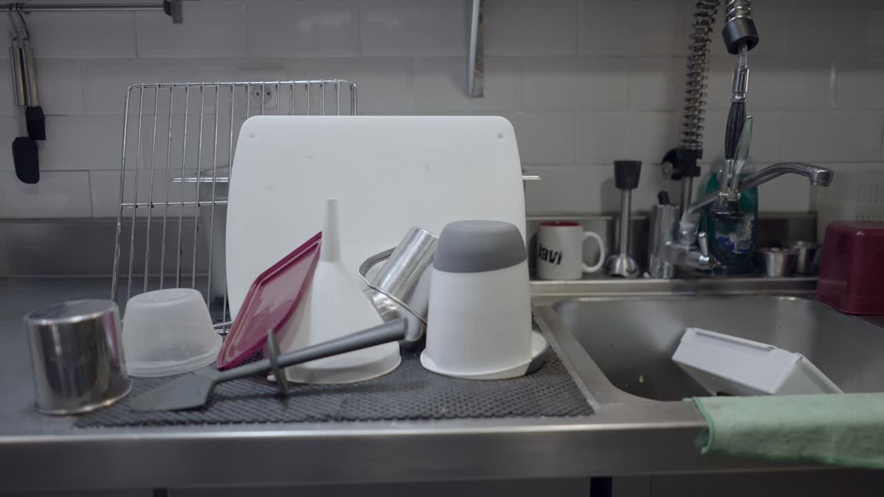 Dirty Dishes and Utensils in a Kitchen Sink