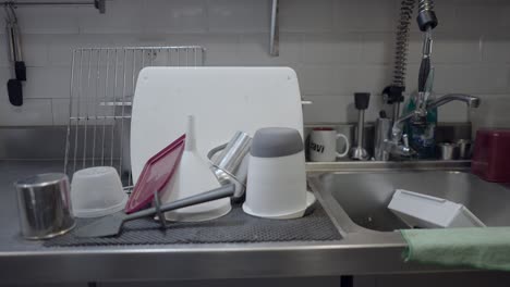 dirty dishes and utensils in a kitchen sink