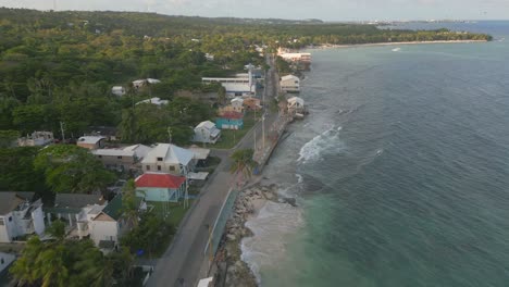 aerial drone flying over small town next to the sea