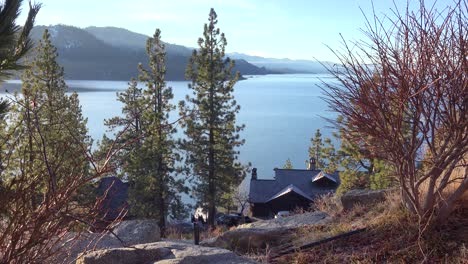 beautiful establishing shot of house mansion or cabin lake tahoe, california, nevada, sierras in winter with snow