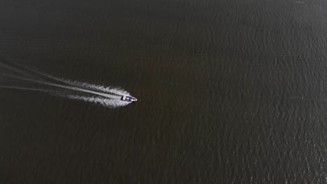 Drone-following-boat-cruising-in-the-water