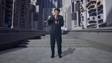 full body of happy asian business man celebrating while using smartphone in city