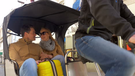 tourists riding cycle rickshaw in tallinn