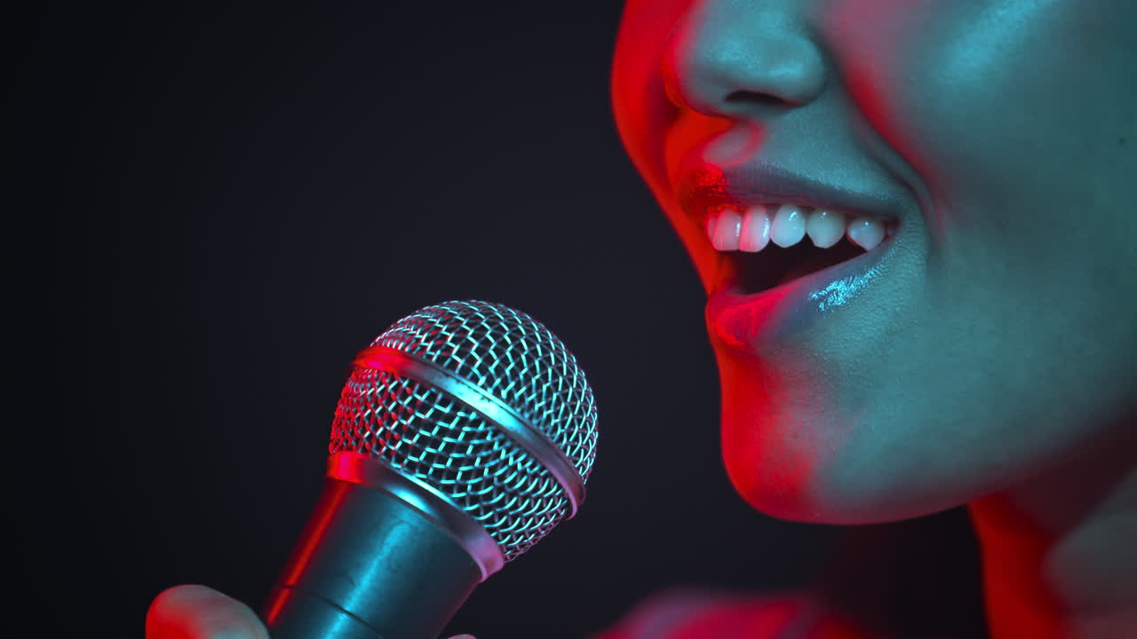 Woman Singing into Microphone in Neon Lights