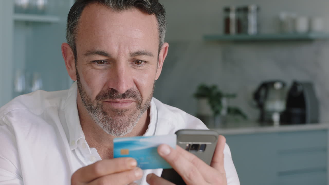 attractive man using smartphone shopping online spending money on credit card mobile banking app with digital currency enjoying financial freedom