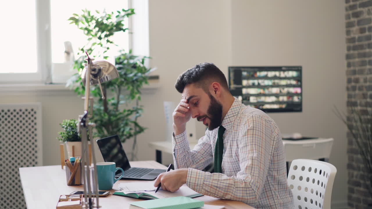 Stressed Businessman Working at His Desk