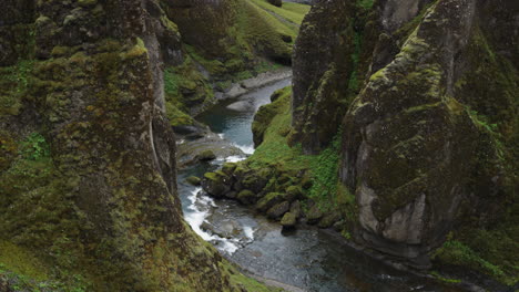 dramatic tilt up to reveal shot of the super cinematic fjadrarglijufur canyon iceland