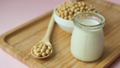 soy milk in a glass jar with soybeans