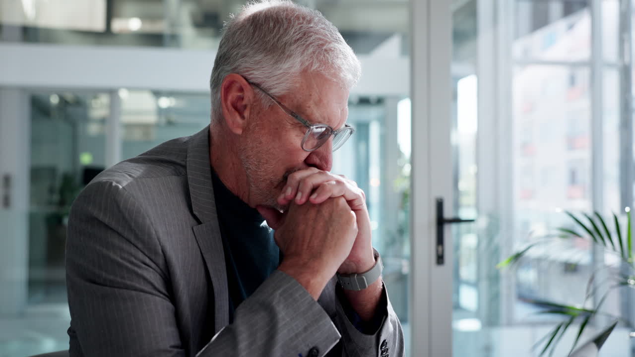 Senior Businessman Working on Laptop and Thinking in Modern Office