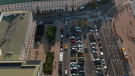 Forwards-tracking-of-cars-driving-along-parking-lot-in-city.-High-angle-view-of-traffic-at-Theatre-Square.-Warsaw,-Poland