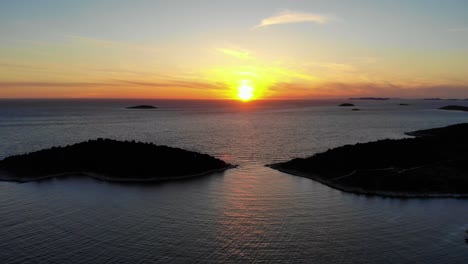 a drone video of a sunset over the island of jaz in croatia