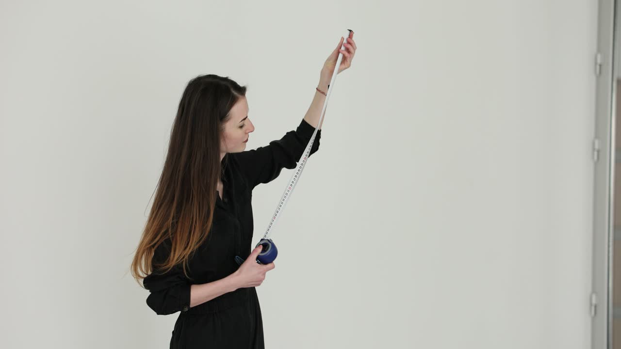 Woman Measuring with Tape Measure