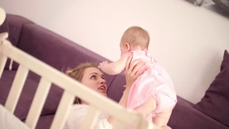 beautiful mom playing with baby. carefree family. cheerful woman happy with baby