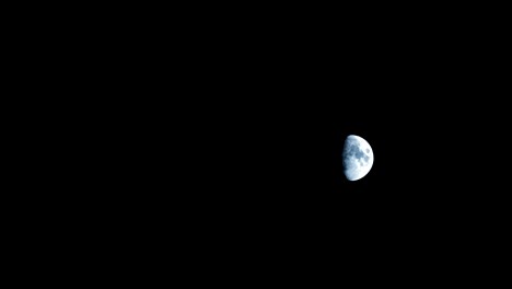 half moon moving on a dark night sky time lapse.