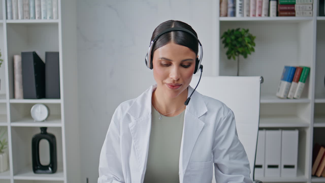 Remote therapist answering call in headset providing healthcare support closeup