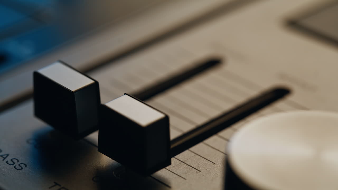 Fingers operating sound balance on retro musical equipment closeup. Hand pushing