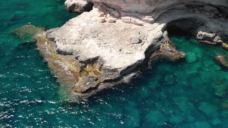 Spain-Mallorca-Cala-Llombards-and-Cala-Santanyi-at-4k-24fps-with-ND-filters-flying-with-a-DJI-Mavic-Air-with-beautiful-views-of-the-beaches,-rocks,-boats-and-blue-water