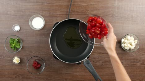 top down shot of a table with single hob and large pan with olive oil on it