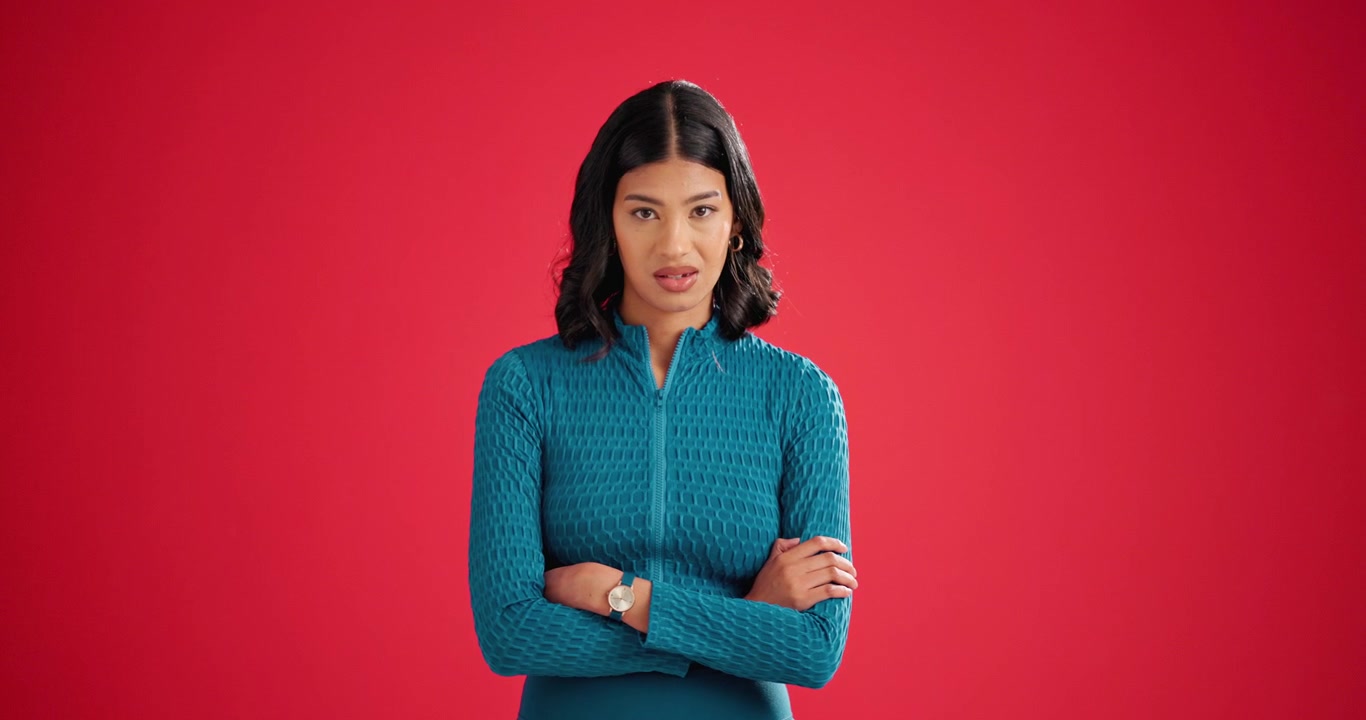 Young Woman Making Funny Faces Against a Red Background