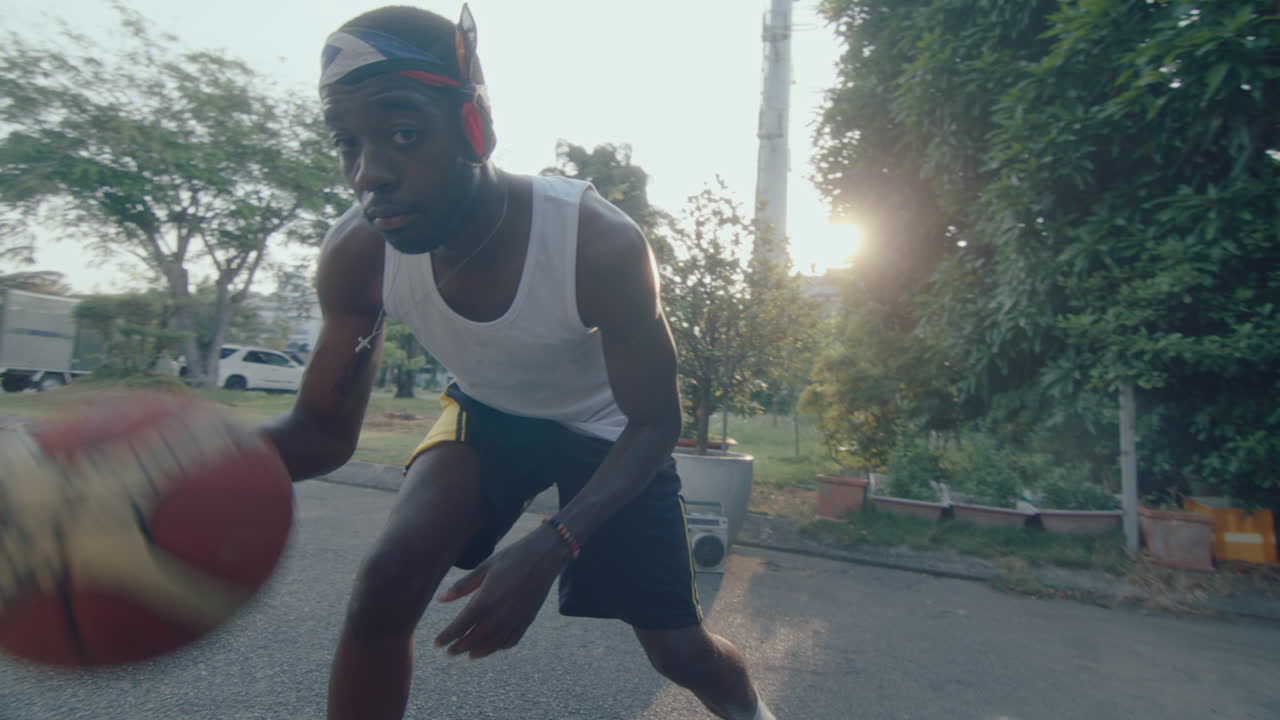 Young African American Man Dribbling Basketball Outdoors