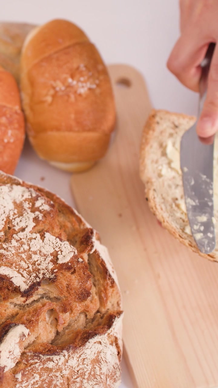 Spreading Butter on a Slice of Fresh Bread