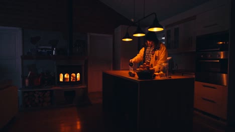 person standing in a small kitchen of a cottage with a fireplace