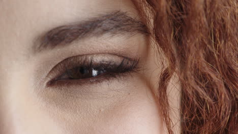 close up of young woman eye looking at camera happy cheerful beautiful detail feminine beauty