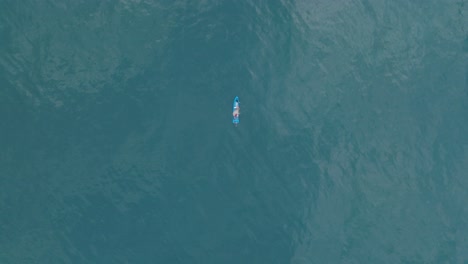 aerial top down drone view of small fishing boat at sea el tunco el salvador