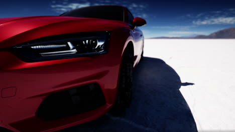 close up of a red car on a salt flat