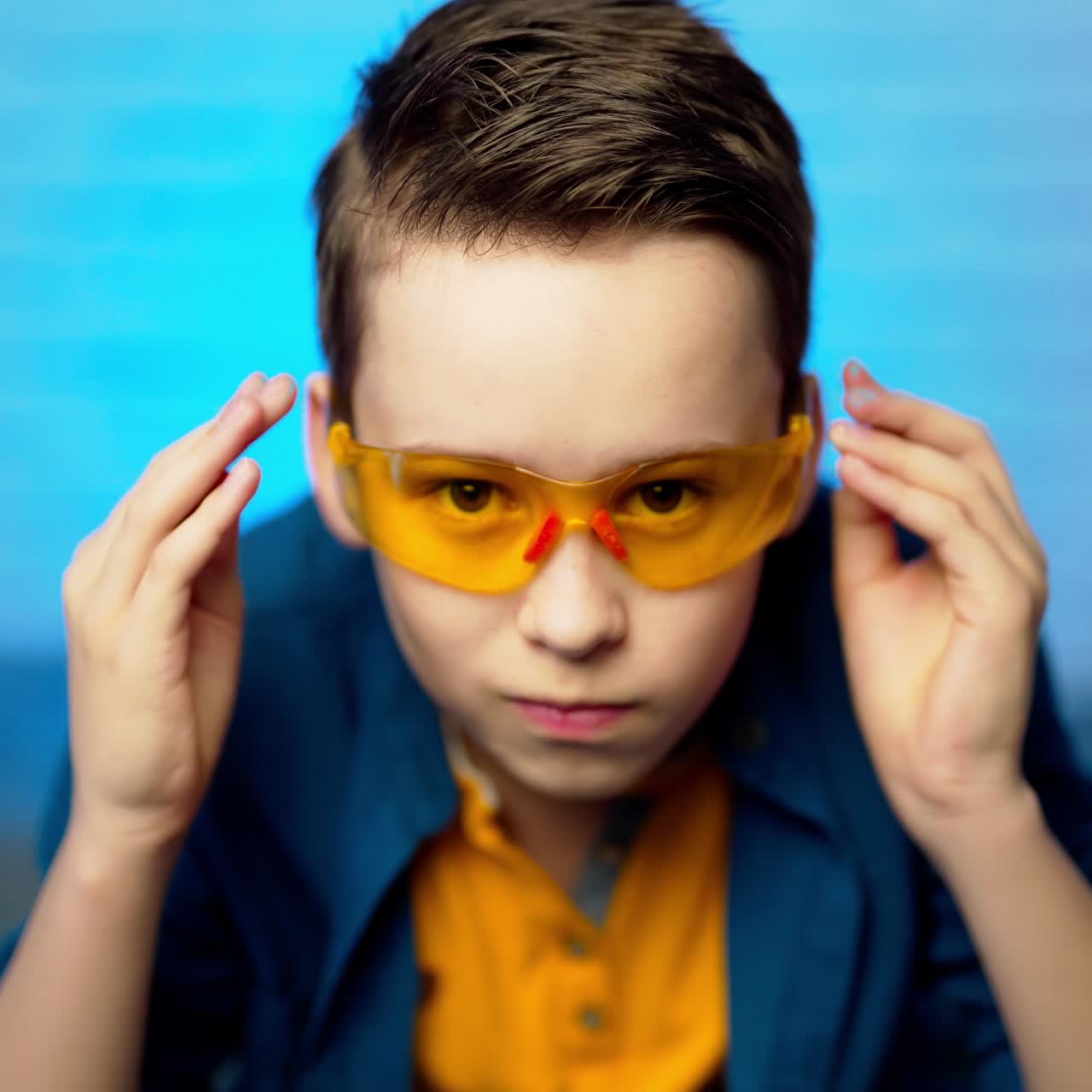 A teenager puts on a protective medical glasses. Stop coronavirus. Stay at home