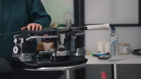 stringing a tennis racket on machine